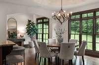 Breakfast nook (more like a room than a nook) connects to the kitchen and overlooks the private back yard and woods beyond. The background space can be office/catch-all or gallery. Leads to back stairway.