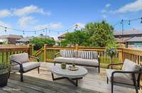 Virtually staged, fantastic back deck overlooking large fenced in backyard