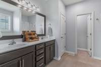 Master bath with double vanities and separate commode room