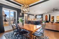 Dining room features a gorgeous tray ceiling with a stained wood accent.