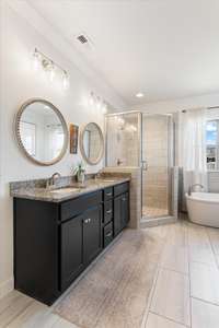 Primary bathroom features double vanities, a soaking tub and walk in shower.