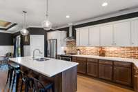 Large oversized island and pendants make a great focal space in this gorgeous kitchen.