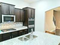 ISLAND WITH GRANITE AND SINK AND BUILT-IN APPLIANCES !!!