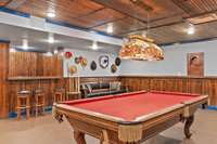 Pool table and refinished/restained wood on the walls and ceiling