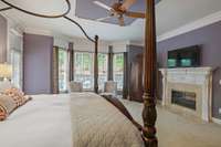 Primary bedroom suite on main floor with double sided fireplace