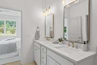 Executive height Vanities w/ Quartz countertops and elegant widespread faucets.