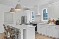 Another look at this stunning kitchen with white cabinets, quartz countertops, Stainless Whirlpool appliances, oversized pantry, and much more!!!