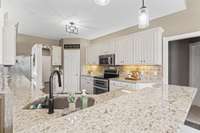 Granite countertops, stainless steel appliances, double oven, under cabinet lighting, and heated tile floors. Central vac system throughout.