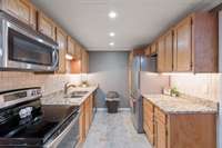 Kitchen in basement apartment. Granite countertops, full size appliances.