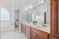 Master bath with 16-ft ceilings, large walk-in shower with two shower heads, body sprayers and large bench, jacuzzi tub, water closet, and heated tile floors