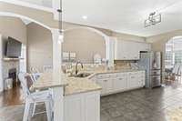 Granite countertops, stainless steel appliances, double oven, under cabinet lighting, and heated tile floors. Central vac system throughout.