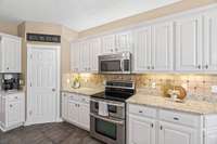 Granite countertops, stainless steel appliances, double oven, under cabinet lighting, and heated tile floors. Central vac system throughout.