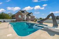 20x40 heated saltwater pool with 10-ft tanning ledge + water slide. Also in the backyard is a professionally installed playground with it's own zip line, and a large patio with built-in fire pit ready for late-night s’mores.