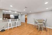 Dining room in basement apartment. Kitchen is to the left. Looks into living room. LARGE flex room through the door on right. Currently being used as a bedroom.