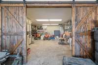 Separate 2-car garage for basement apartment. Workshop area in the back past the barn doors.