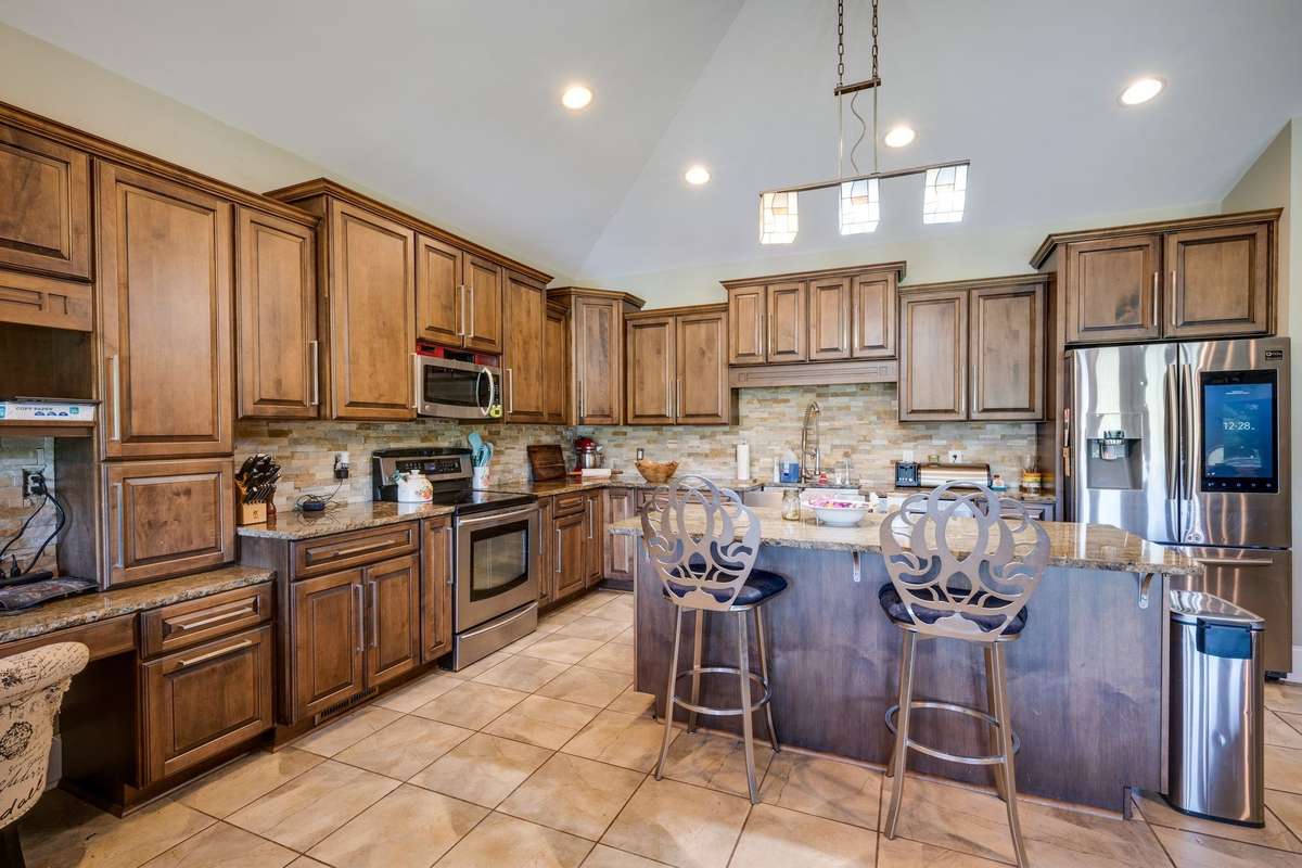 There are so many beautiful kitchen cabinets and the island where you can pull up your own bar stools.
