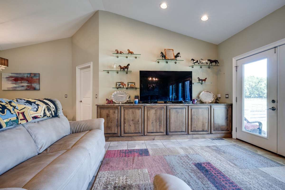 Another view of living area and a door to outside.