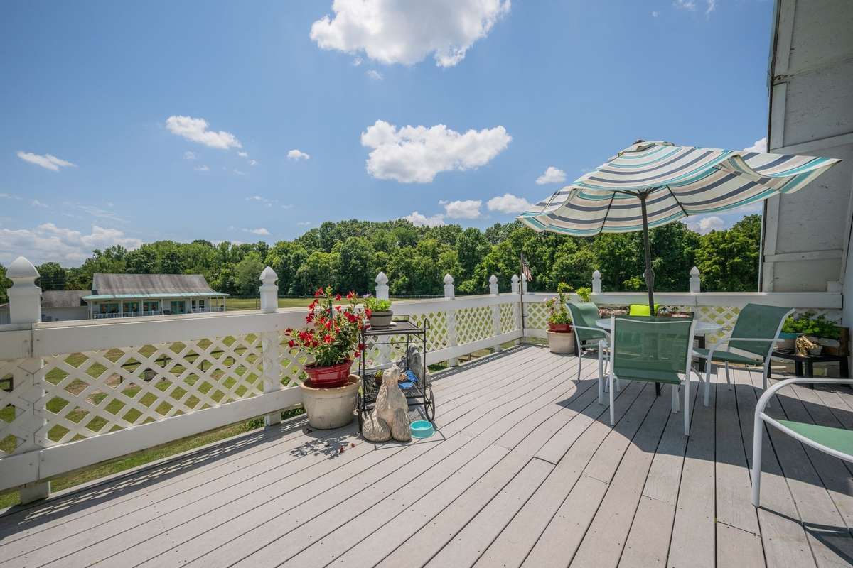 Deck of Bardominium looks out over pasture land.