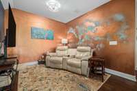 Formal dining room currently used as a den.  Seller has a vibrant color pallet and is offering a concession towards paint if buyer prefers a more neutral color.