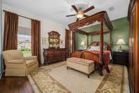 Primary bedroom with plenty of space for large furniture, seating, and two windows for natural light.  Laminate plank flooring installed as an upgrade for a flow from the rest of the living areas.