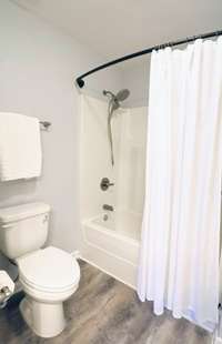 Upstairs bathroom with combination shower & tub serves both upstairs bedroom