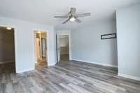 Upstairs bedroom looking towards the closet, bathroom entry and landing area.