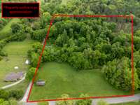 Approximate property lines. Additional land across the street from brick house.