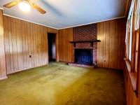 Living room with handcrafted fireplace mantel.