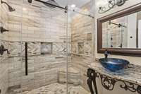 Custom floor-to-ceiling tile in the guest shower