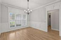 Formal Dining with wainscot, chairrail, crown and custom mouldings around windows and cased openings.