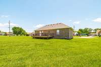 The spacious and level backyard provides plenty of room for play, gardening, or future projects.
