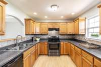 The kitchen features ample cabinet and counter space, ideal for cooking and storage.