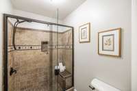 The primary bath features a tile shower with a modern look and easy maintenance.