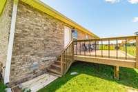 A large deck overlooks the expansive backyard—ideal for relaxing or entertaining.