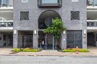 Street view of the front of the building and the security gate.