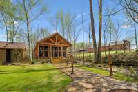 The Event Venue with storage area to the left, creek in the middle and the Main Lodge up the hill to the right