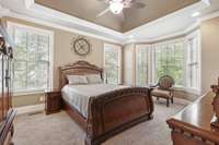 Primary suite with bay window overlooking the backyard