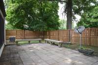 The private back patio is great for family and pets. The stone floor, fencing with/ gate, and patio benches are just a few of the highlights. Imagine your hanging patio lights strung up and casting a restful glow on this space at the end of your day.