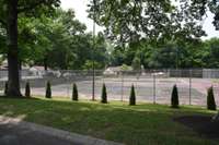 Large swimming pool just beyond the tennis courts.