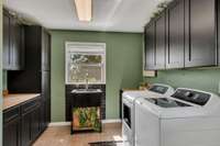 *ELEVATED LAUNDRY ROOM WITH A SINK, TONS OF CABINETRY AND COUNTER SPACE TO FOLD LAUNDRY!*