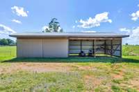 *GARAGE/SHED WITH COVERED ARE PERFECT FOR YOUR EQUIPMENT* SLIDING DOOR OPENS UP*