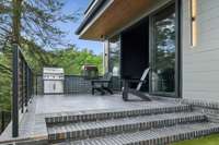 The patio off the sunroom includes an artisan grill and a gas pizza oven.