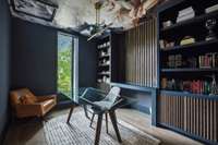 This office includes custom built-in bookcases with a view out of the front of the home.