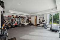This dedicated gym has rubber floors and a full bath. Gym equipment/mounts do not convey with the home.