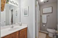 Crisp and classic vanity space with plenty of countertop room and under-sink storage.