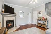 Welcome to this charming condo with rich hardwoods, crown molding, cozy gas fireplace, and arched accents. Neutral tones and natural light create a warm, inviting space ready for your personal touch!