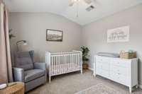 Versatile upstairs bedroom with vaulted ceilings—perfect as a nursery, guest room, or peaceful home office.