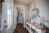 Step into the cheery foyer, the roomy powder room to the left.