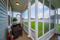 Back downstairs, the back door leads to a covered and screened in porch/patio, perfect for relaxing and entertaining.
