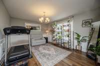 This charming space can be used as you wish - dining room, living room, office - or, as here, workout room!